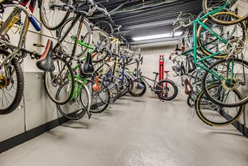 a row of bikes hanging on a wall in a garage